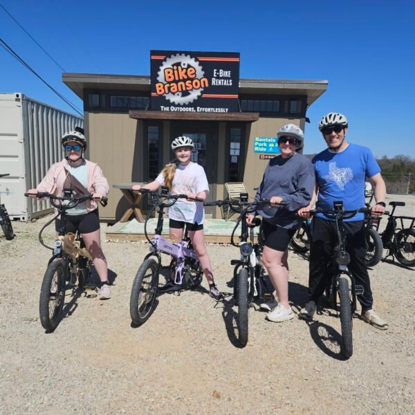 Man, woman, 2 children on bikes.